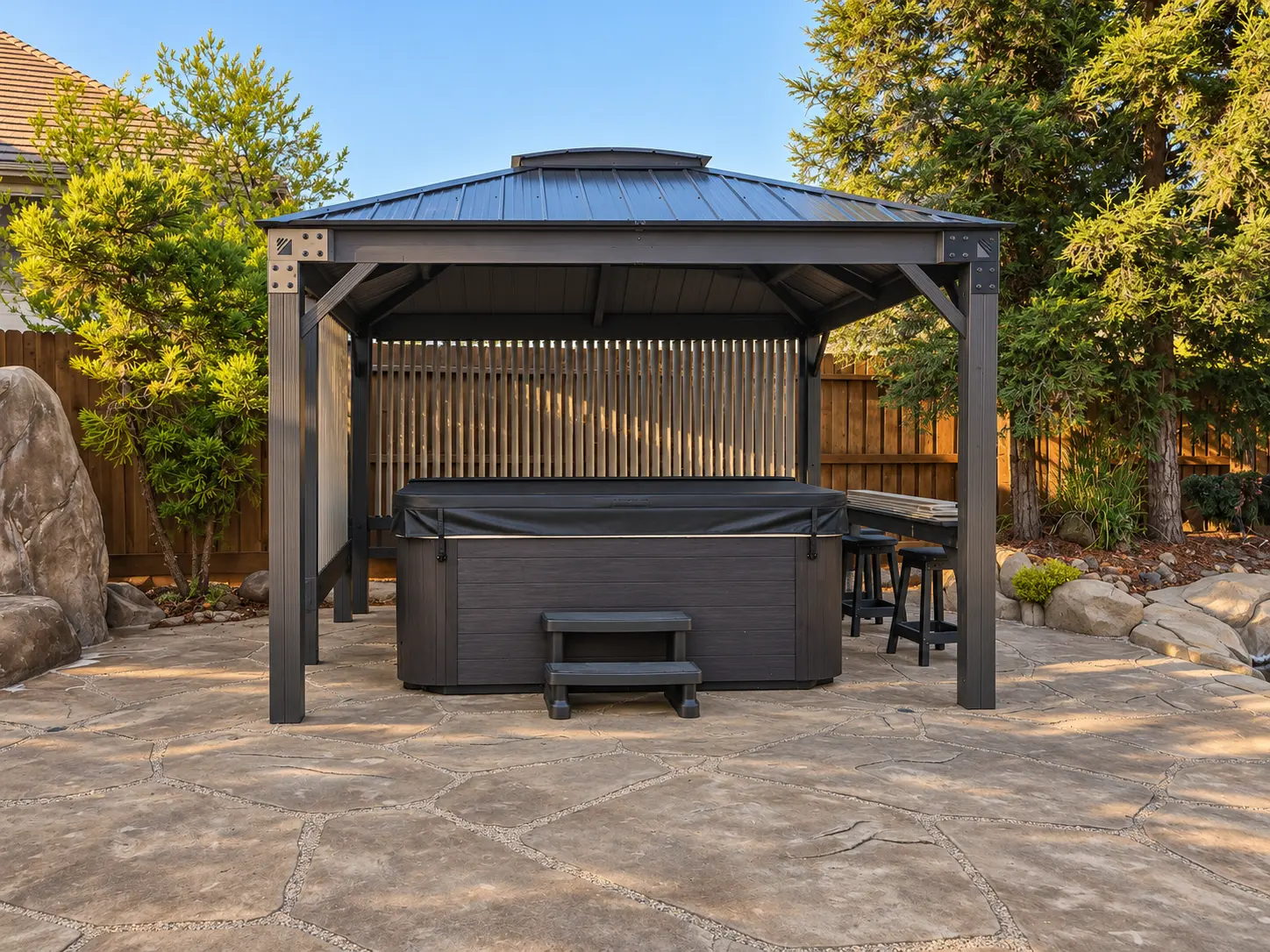 Finished gazebo installation sheltering a backyard hot tub